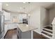 Spacious kitchen with granite island, white cabinets, stainless appliances and a view of the staircase at 2848 Grand Union Way, Charlotte, NC 28209