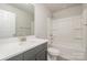 Clean bathroom with gray vanity, quartz countertop, and shower/tub combo at 336 E Lincoln St, Concord, NC 28025