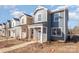 Two-story townhome with gray siding, white trim, and a front porch at 336 E Lincoln St, Concord, NC 28025