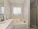 Bathroom with double vanity, soaking tub, and shower at 364 Holstein Dr, Dallas, NC 28034