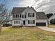 Two-story house with gray siding, black shutters, and a two-car garage at 364 Holstein Dr, Dallas, NC 28034