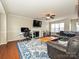 Spacious living room with a large sectional sofa, hardwood floors, and a fireplace at 364 Holstein Dr, Dallas, NC 28034