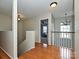 Upstairs hallway with hardwood floors and access to bedrooms at 364 Holstein Dr, Dallas, NC 28034