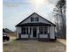 New construction home with white siding, black accents, and a brick base at 401 Fourth St, Stanley, NC 28164