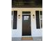 Modern front door with black finish and welcoming mat at 401 Fourth St, Stanley, NC 28164