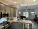 Open kitchen features granite countertops and island with seating at 401 Fourth St, Stanley, NC 28164