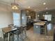 Spacious kitchen boasts granite counters, island, and dining area at 401 Fourth St, Stanley, NC 28164
