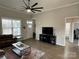 Living room with hardwood floors, ceiling fan, and access to other rooms at 401 Fourth St, Stanley, NC 28164