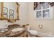 Powder room with marble vanity and decorative mirror at 4421 Windwood Cir, Charlotte, NC 28226