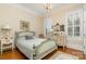 Well-lit bedroom with hardwood floors and built-ins at 4421 Windwood Cir, Charlotte, NC 28226