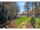 Landscaped backyard with stone path leading to lake access at 4628 Rustling Woods Dr, Denver, NC 28037