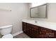 Bathroom featuring dark wood vanity, white countertop, and a framed mirror at 4723 Polo Gate Blvd, Charlotte, NC 28216