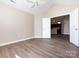 Open bedroom featuring neutral walls and an open door to the kitchen at 4723 Polo Gate Blvd, Charlotte, NC 28216