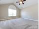 Spacious bedroom featuring neutral walls, carpet, and ceiling fan at 4723 Polo Gate Blvd, Charlotte, NC 28216
