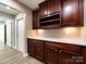 Well appointed butler pantry with dark wood cabinets, wine rack, and countertop space at 4723 Polo Gate Blvd, Charlotte, NC 28216