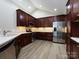 Modern kitchen featuring stainless steel appliances, dark wood cabinets, and ample lighting at 4723 Polo Gate Blvd, Charlotte, NC 28216