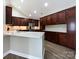 Kitchen with stainless steel appliances, white countertops, and dark wood cabinetry at 4723 Polo Gate Blvd, Charlotte, NC 28216