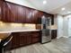 Modern kitchen featuring stainless steel appliances, dark wood cabinets, and ample lighting at 4723 Polo Gate Blvd, Charlotte, NC 28216
