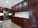 Kitchen with stainless steel appliances, white countertops, and dark wood cabinets at 4723 Polo Gate Blvd, Charlotte, NC 28216