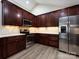 Modern kitchen featuring stainless steel appliances, dark wood cabinets, and ample lighting at 4723 Polo Gate Blvd, Charlotte, NC 28216