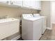 Functional laundry room with white cabinets, a sink, and a washer and dryer at 4723 Polo Gate Blvd, Charlotte, NC 28216
