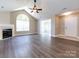 Living room with hardwood floors, fireplace, and sunroom access at 4723 Polo Gate Blvd, Charlotte, NC 28216