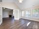 Spacious living room with hardwood floors, a fireplace, and bright natural light at 4723 Polo Gate Blvd, Charlotte, NC 28216