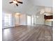 Open living area with hardwood floors, sunroom access, and kitchen view at 4723 Polo Gate Blvd, Charlotte, NC 28216