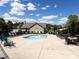 Community pool area with ample seating and a clubhouse under a bright sky at 4723 Polo Gate Blvd, Charlotte, NC 28216