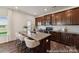 Modern kitchen featuring granite countertops and dark wood cabinetry at 5008 Mooreland Oaks Way # 134P, Mount Holly, NC 28120