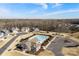 Aerial view of the community pool, clubhouse and playground surrounded by mature trees at 5034 Moselle Ave, Fort Mill, SC 29707