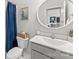 Neutral bathroom featuring a round mirror and shower with blue curtain at 5034 Moselle Ave, Fort Mill, SC 29707