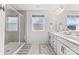Bathroom features a double vanity, a large mirror, and a glass enclosed shower at 5034 Moselle Ave, Fort Mill, SC 29707