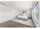 Bright bedroom with hardwood floors, large windows, and comfortable furnishings create inviting space at 5034 Moselle Ave, Fort Mill, SC 29707