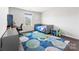 A bedroom features ample light, a desk, and colorful carpet at 5034 Moselle Ave, Fort Mill, SC 29707