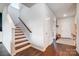 Bright entryway with hardwood floors leading to staircase with wooden handrail and white trim at 5034 Moselle Ave, Fort Mill, SC 29707