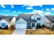 Charming two-story home featuring a front-facing garage and a welcoming front porch, set against a beautiful blue sky at 5034 Moselle Ave, Fort Mill, SC 29707