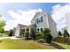 Charming two-story home with light green siding, a covered front porch, well-manicured lawn, and professionally landscaped flower beds at 5034 Moselle Ave, Fort Mill, SC 29707