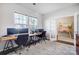 Bright home office space featuring a long desk with monitors and two large windows with blinds at 5034 Moselle Ave, Fort Mill, SC 29707