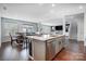Open kitchen view with stainless steel appliances, white countertops and an island with an eating area at 5034 Moselle Ave, Fort Mill, SC 29707