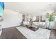 Spacious open-concept living area showcasing hardwood floors and seamlessly connected kitchen and dining spaces at 5034 Moselle Ave, Fort Mill, SC 29707