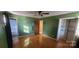 Bedroom with wood floors, a closet, and green walls at 5527 Dallas High Shoals Hwy Hwy, Dallas, NC 28034
