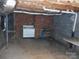Unfinished basement area with vintage stove, bare ceiling, and concrete flooring; awaiting personalization and customization at 5590 S Nc 16 Business Hwy, Maiden, NC 28650