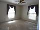 Bedroom with two windows, ceiling fan, and carpet flooring at 5590 S Nc 16 Business Hwy, Maiden, NC 28650
