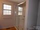 Neutral bathroom featuring a glass-enclosed shower and window at 5590 S Nc 16 Business Hwy, Maiden, NC 28650