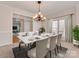 Elegantly staged dining room with a marble-topped table, seating for six, and decorative accents at 5954 Rathlin Nw Ct, Concord, NC 28027