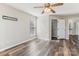 Well-lit bedroom featuring wood-look flooring, a ceiling fan and a walk-in closet at 6015 Queens Walk Ct, Fort Mill, SC 29707