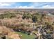 Aerial view showcasing a lakefront property with lush trees and neighboring houses at 604 Beaten Path Rd, Mooresville, NC 28117