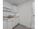 White kitchen with granite countertops and dishwasher at 604 Beaten Path Rd, Mooresville, NC 28117
