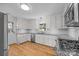 Renovated kitchen with white cabinets, granite counters, and stainless steel appliances at 604 Beaten Path Rd, Mooresville, NC 28117